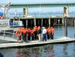 Sea Cadets line up on the dock, prior to jumping into 58 water with Survival Suits. Photo by CWO F. Woodward, NSCC